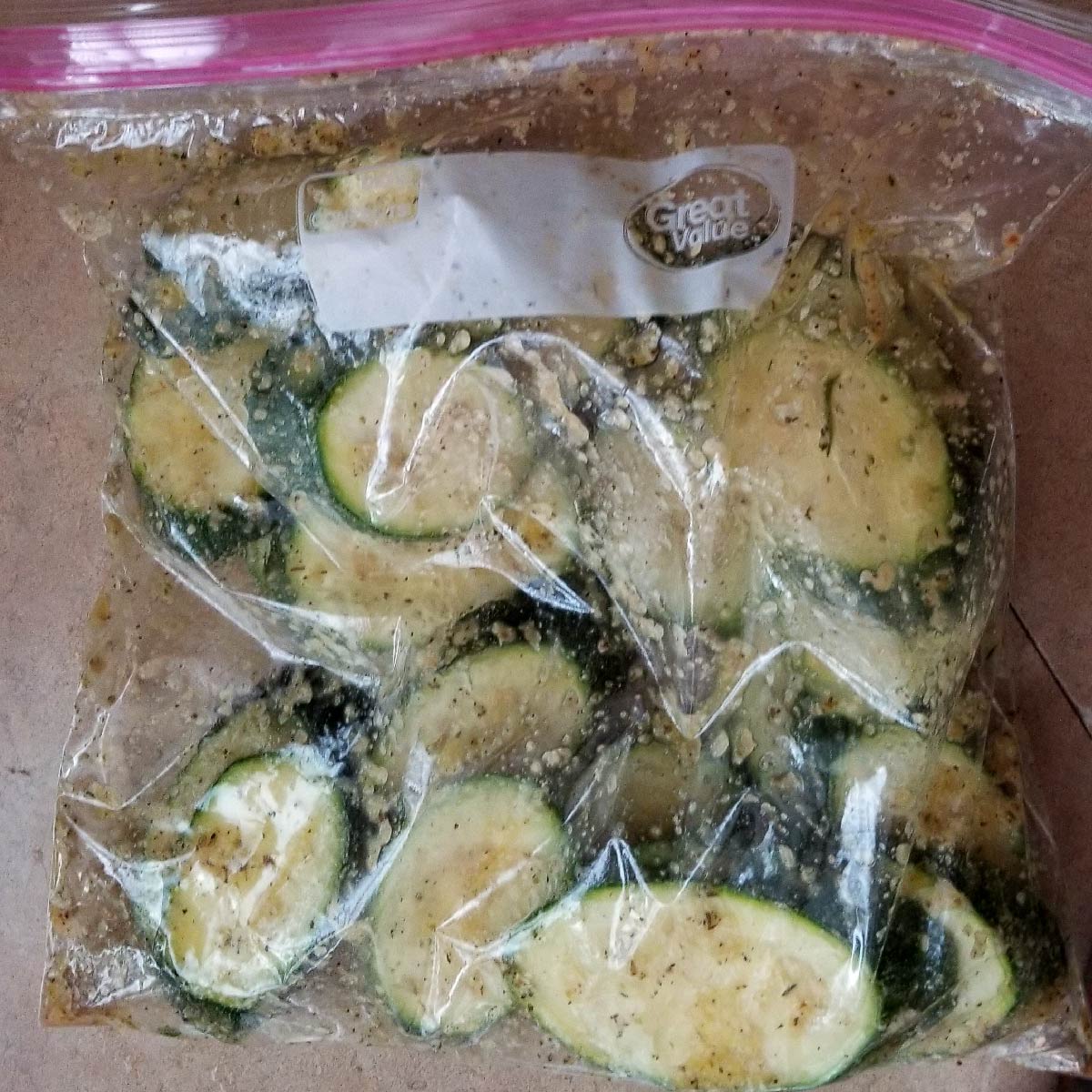 Zucchini sliced and in a storage bag to coat with seasoning mix.