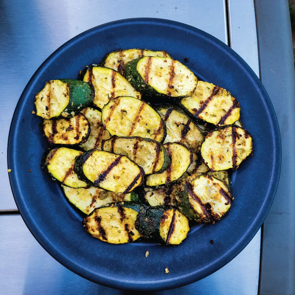 Zucchini slices on a plate ready to be served after being grilled.