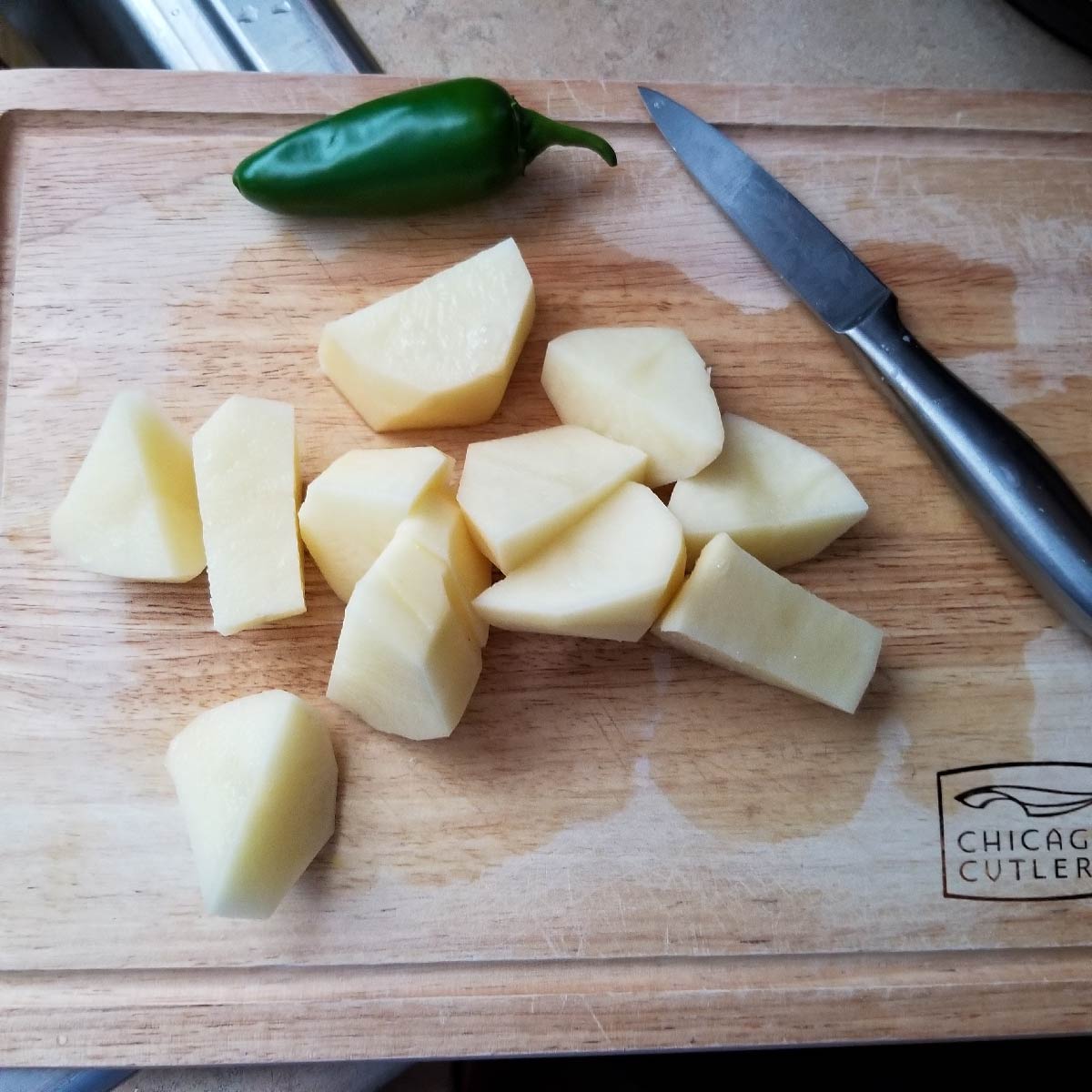 Potatoes cut into chunks about 2 inches by 1 inch thick.