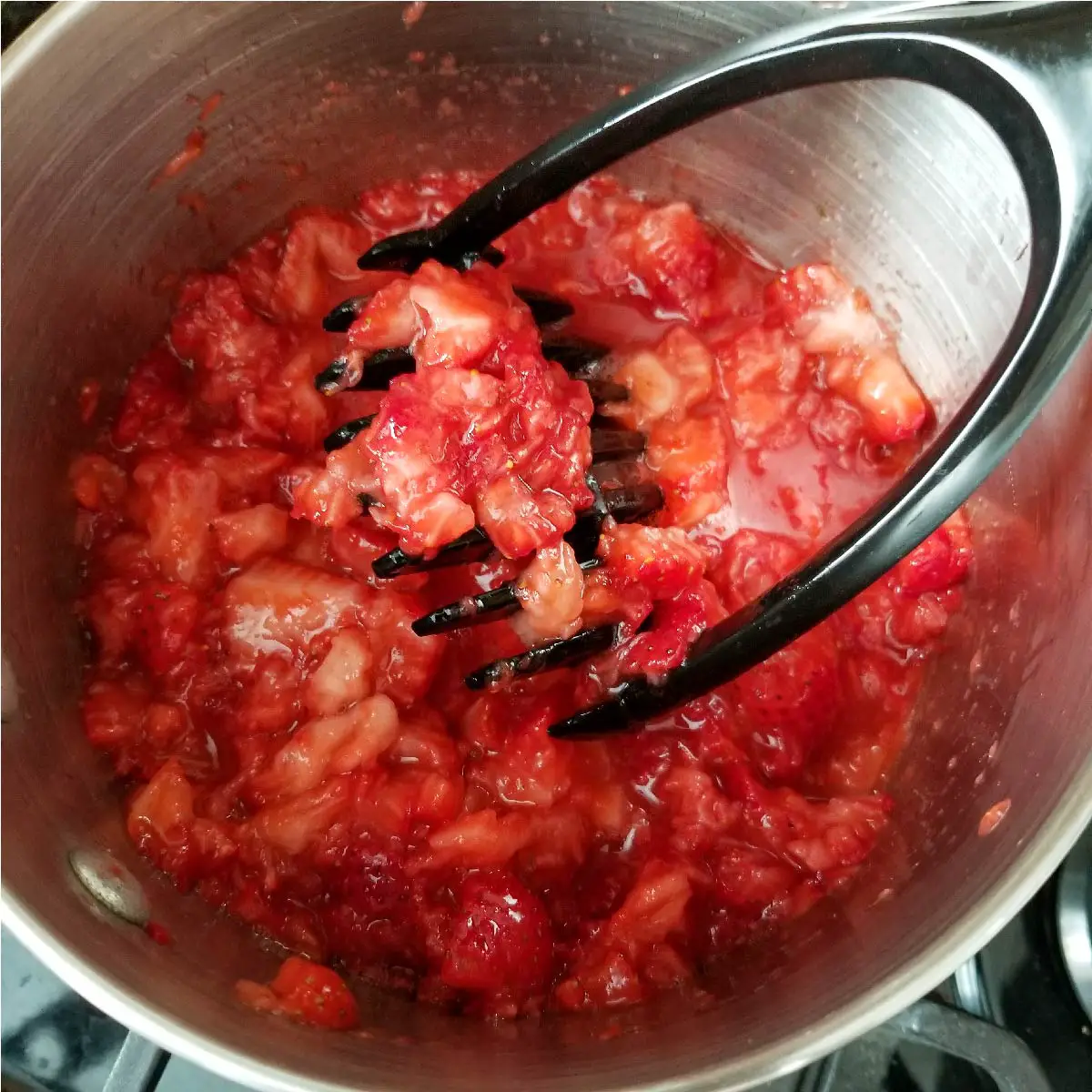 Strawberries mashed for dessert topping before heating