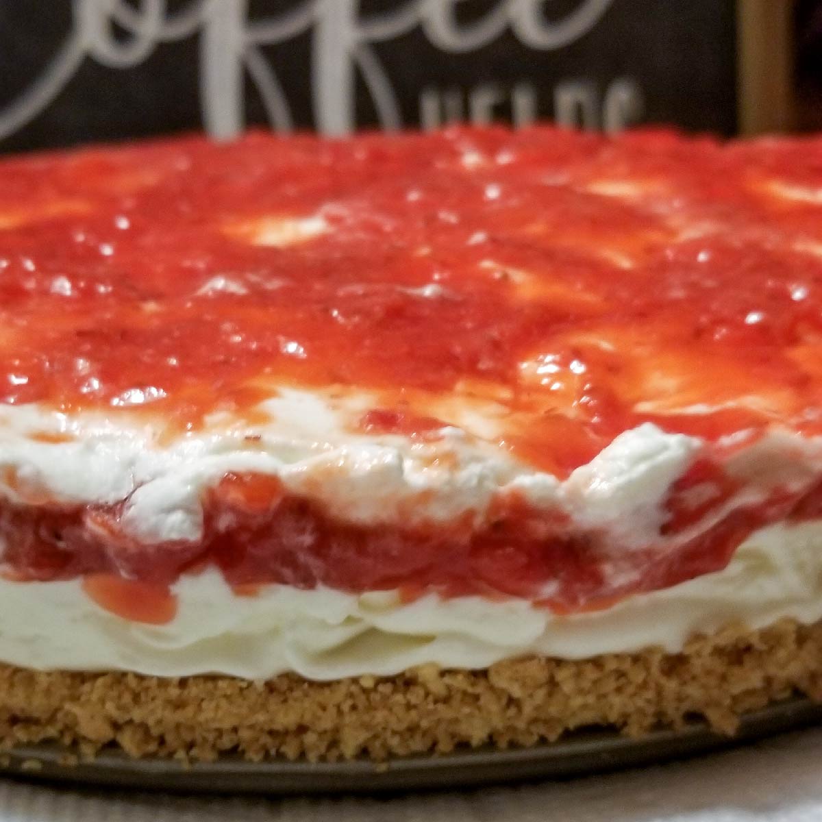 Strawberry cheesecake in a springform pan just before serving