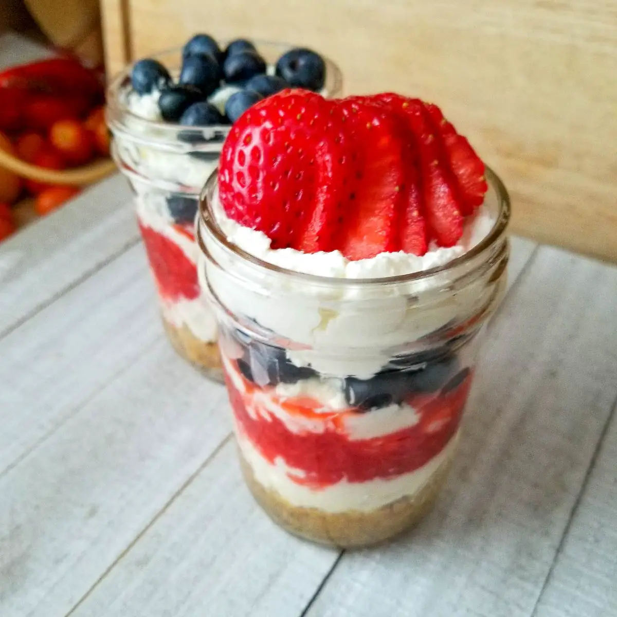 cheesecake with berries in half pint canning jars as a single serving