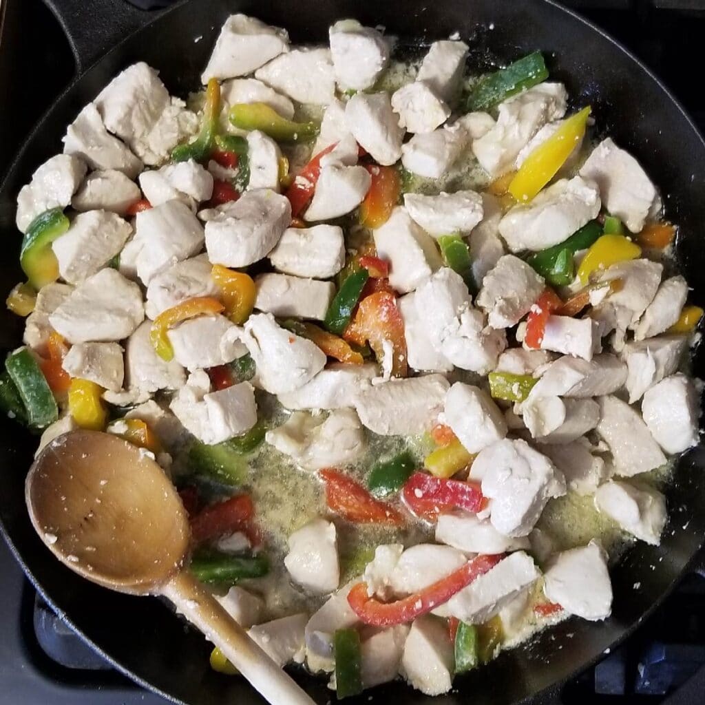 chicken and peppers in the cast iron skillet