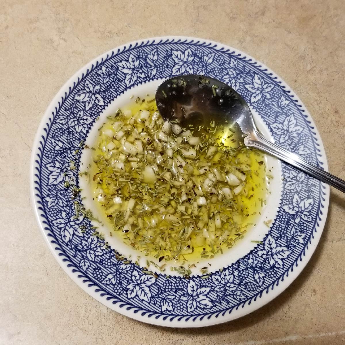 Garlic, salt, pepper and rosemary soaking in olive oil to put on the roast.