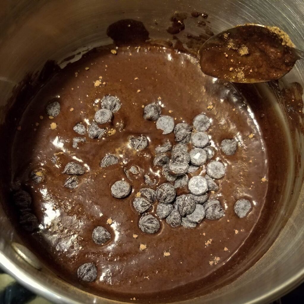 Adding the chocolate chips to the mix to melt them.