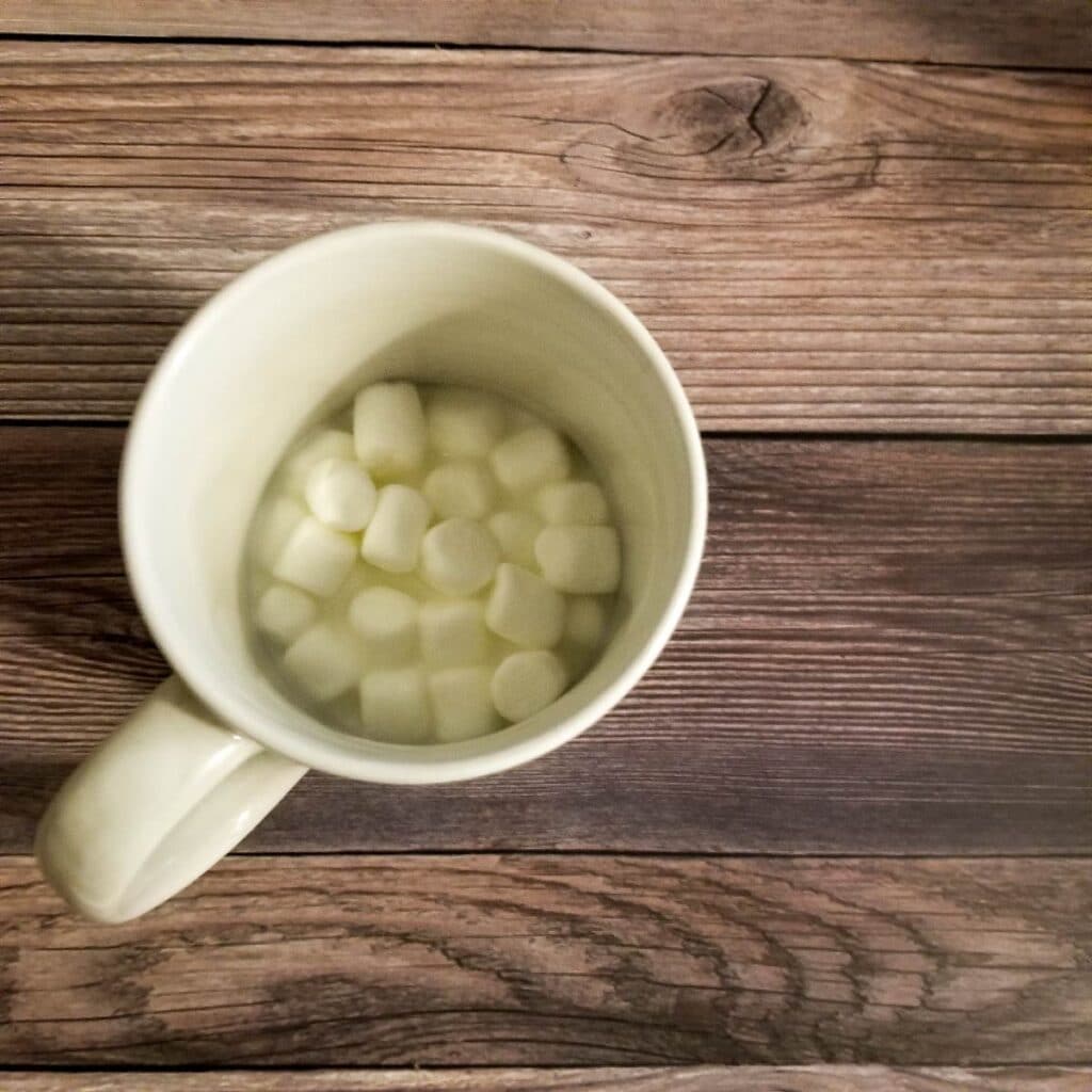 Marshmallows in the cup with milk before heating it to make froth