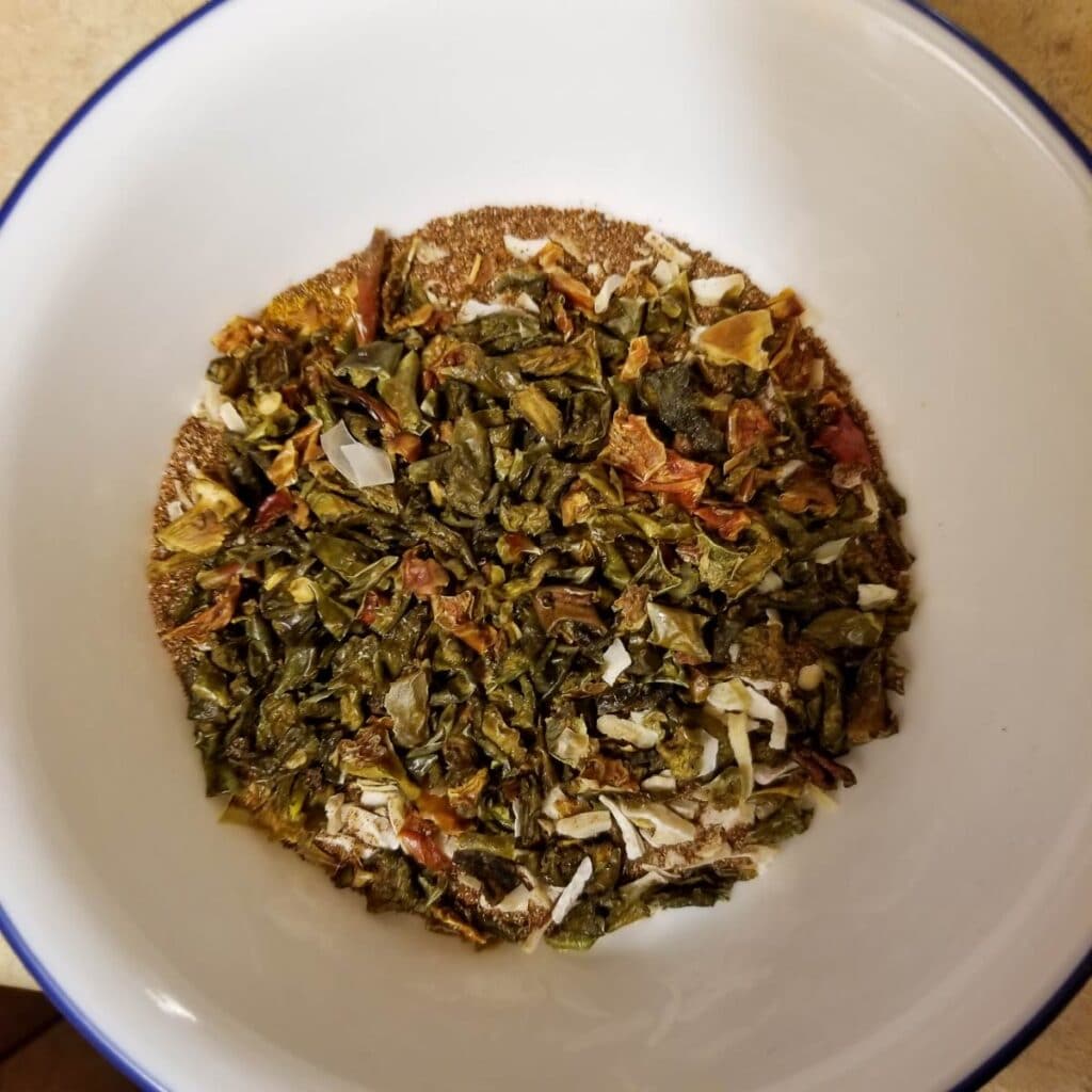 Taco seasoning mixed in the bowl with dried peppers, ready to be put into the meal