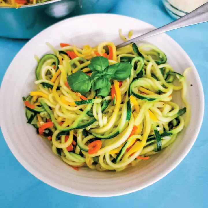 Spiralized veggie noodles coated in a garlic sauce in a serving bowl ready to eat