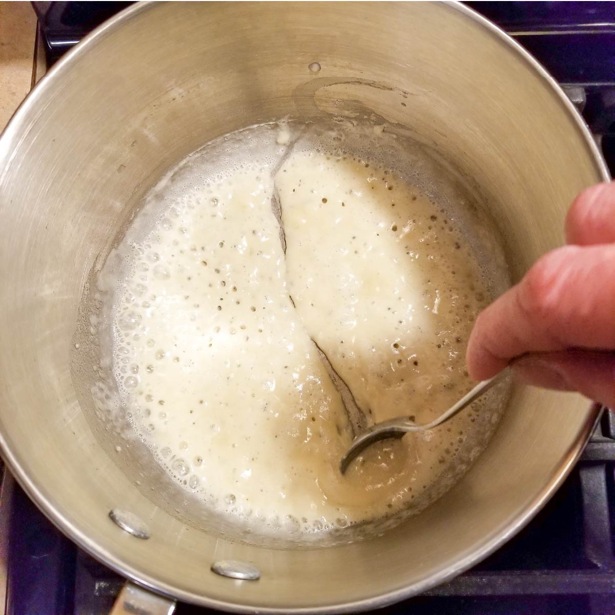 The flour and butter in the pan should be thick like this before adding the milk and cream.