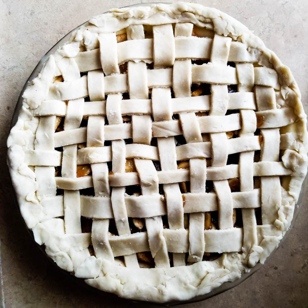 Lattice crust on top of the pie that is ready to go in the oven.