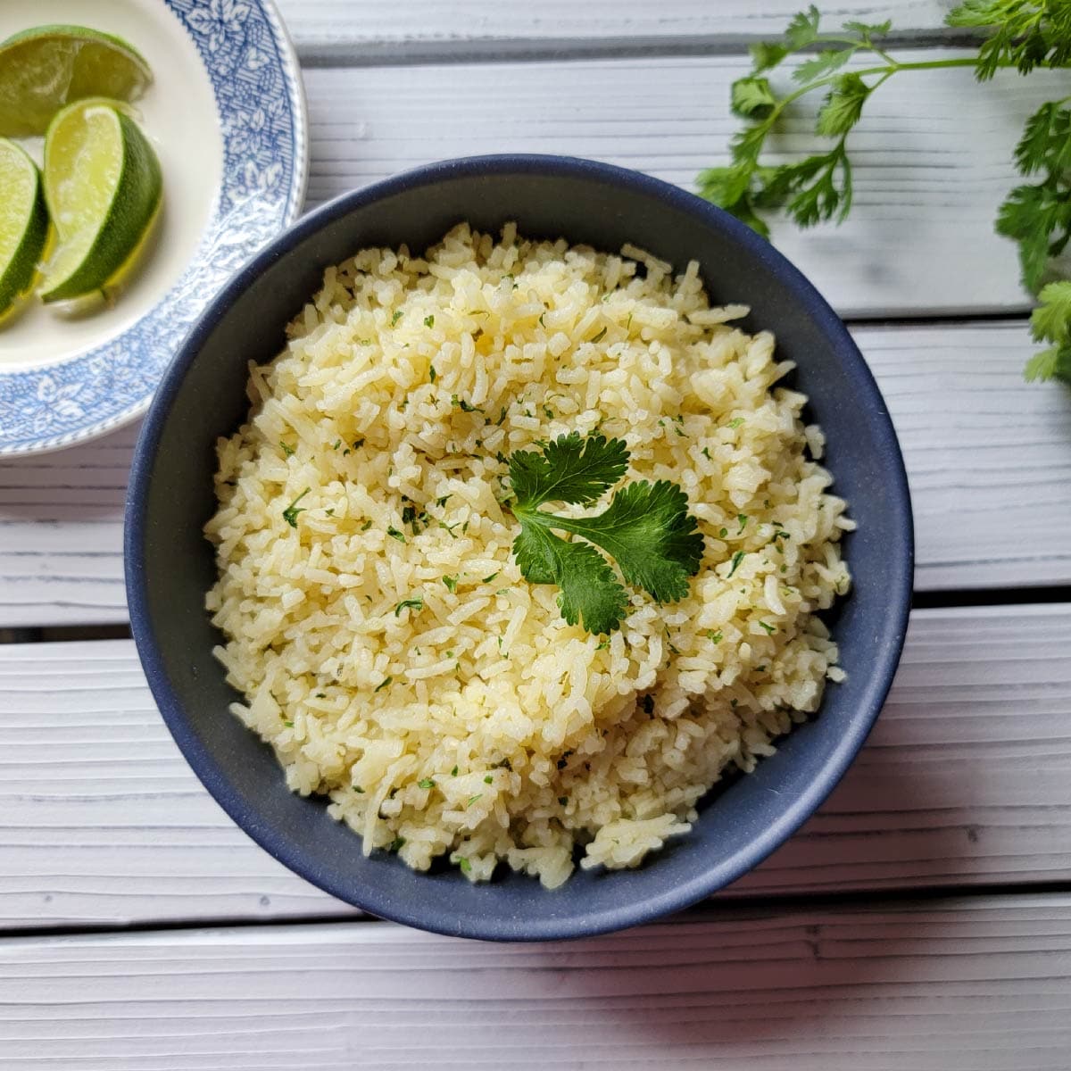 rice prepared in a dish ready to be served with lime on a plate next to it for decoration