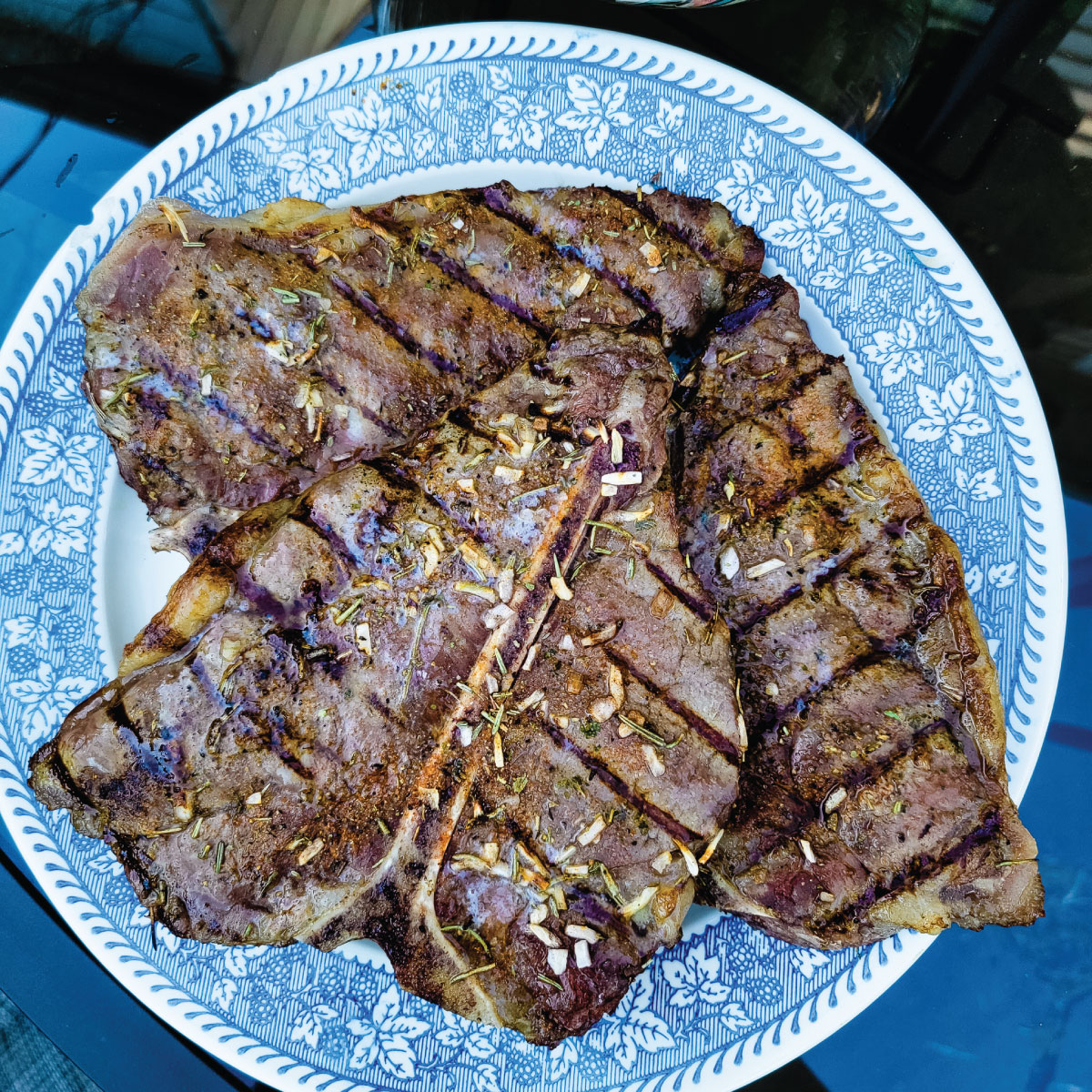 T-bone steaks on a plate resting after being grilled