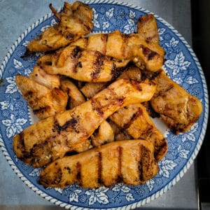 Marinated chicken on a plate after being grilled, ready to serve