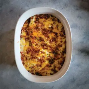 Mashed potato casserole in a baking dish after baking ready to serve.