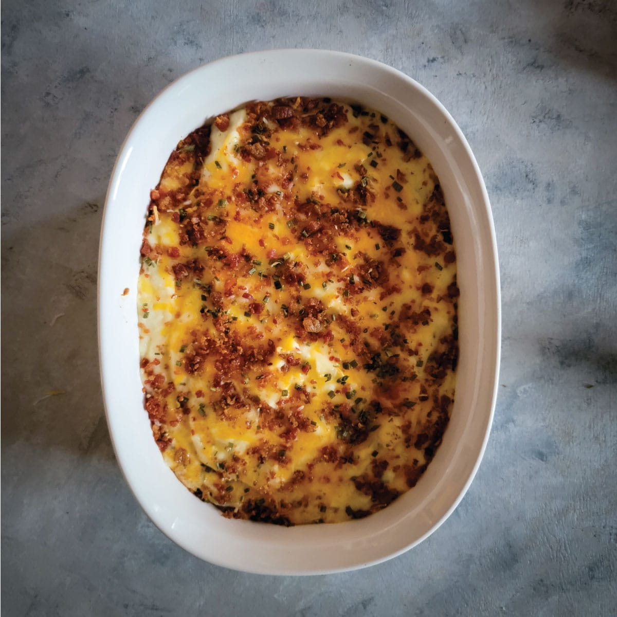 Mashed potato casserole in a baking dish after baking ready to serve.