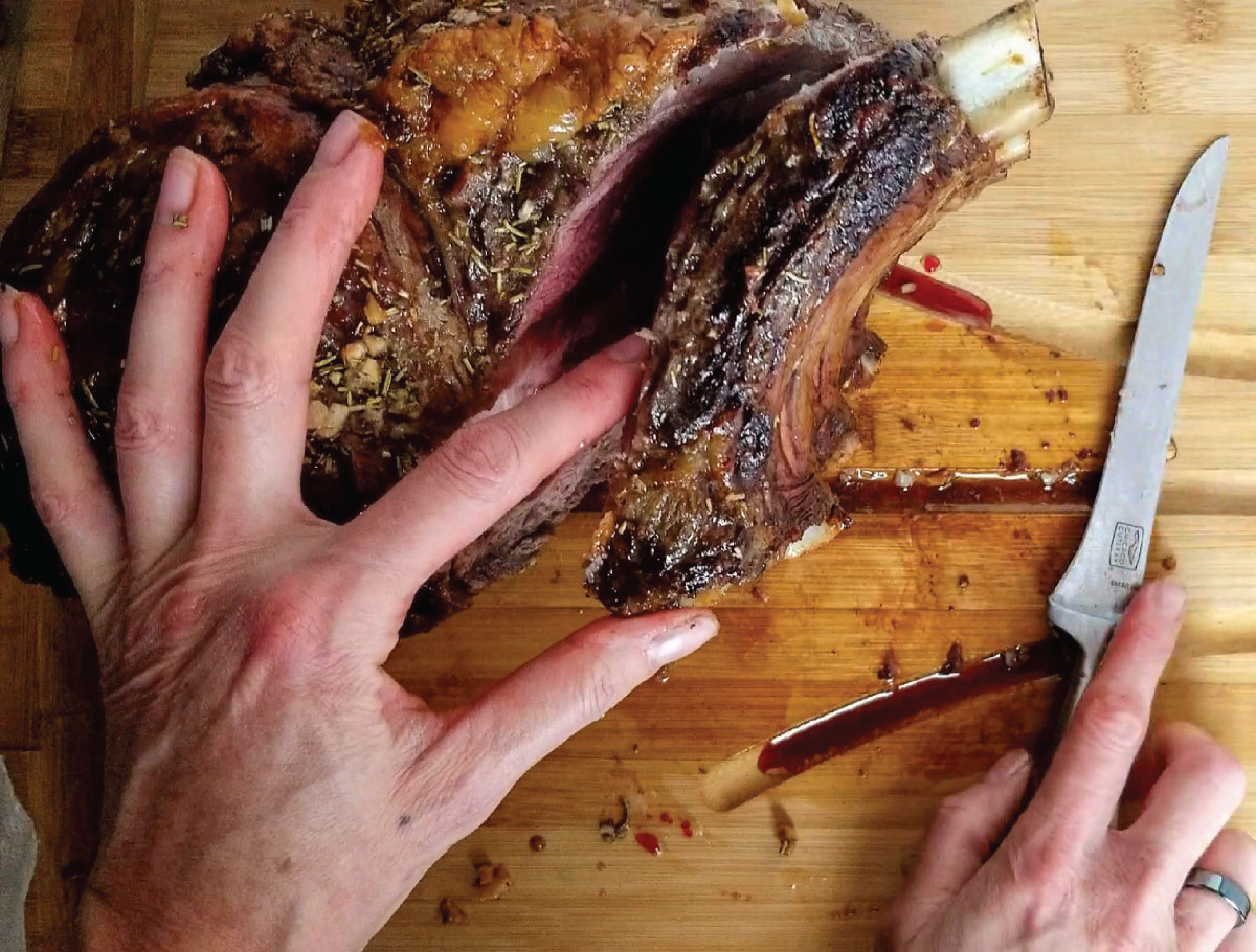 roast on it's side after being cut along the bones to show where to cut.