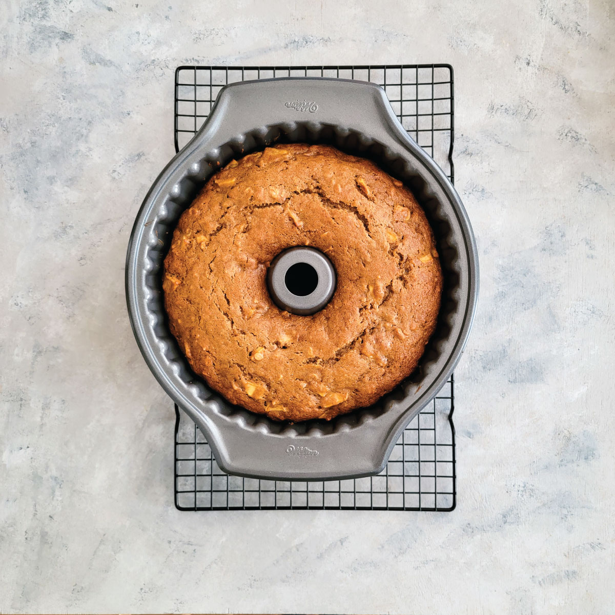 Apple cake still in the bundt pan to cool down after coming out of the oven.