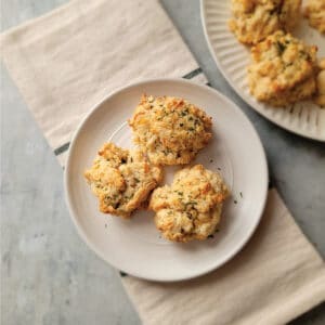 3 biscuits on a serving plate garnished with parsley ready to eat.