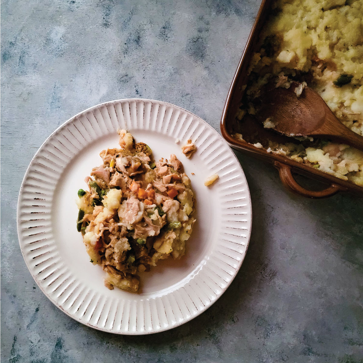 Turkey casserole spooned out onto a dinner plate to be served.