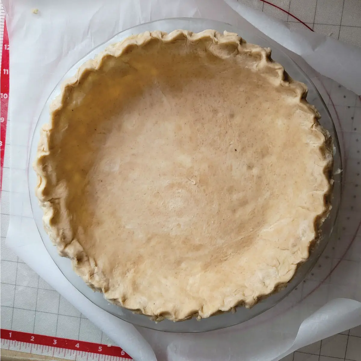 Homemade pie dough in a pie plate ready to add filling.