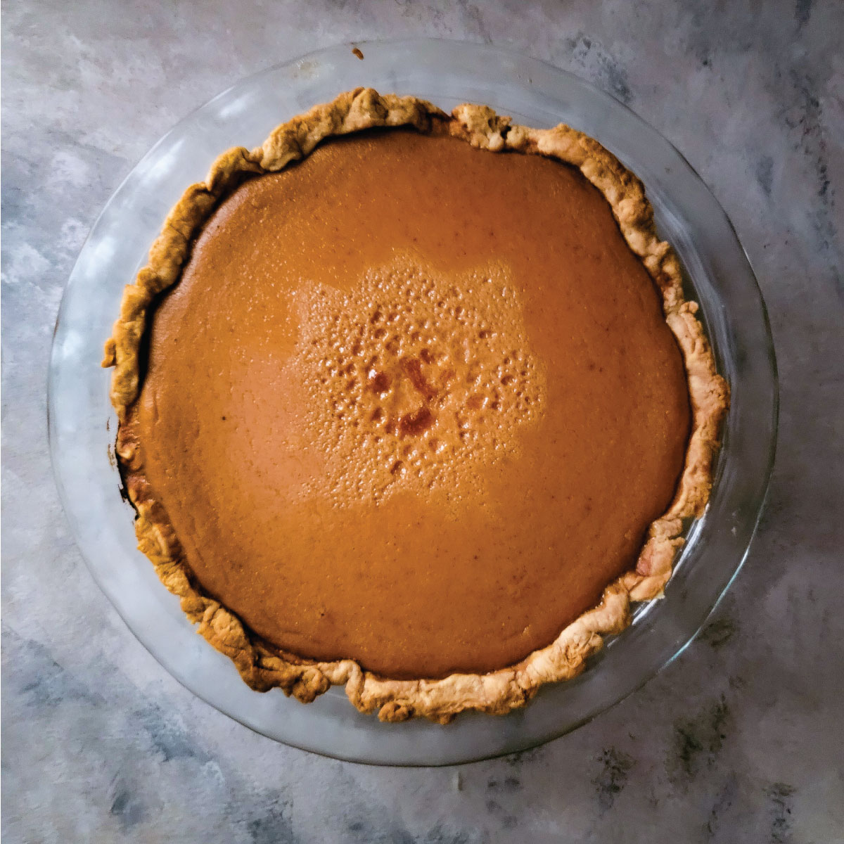 Pumpkin pie in the pie dish after cooling down.