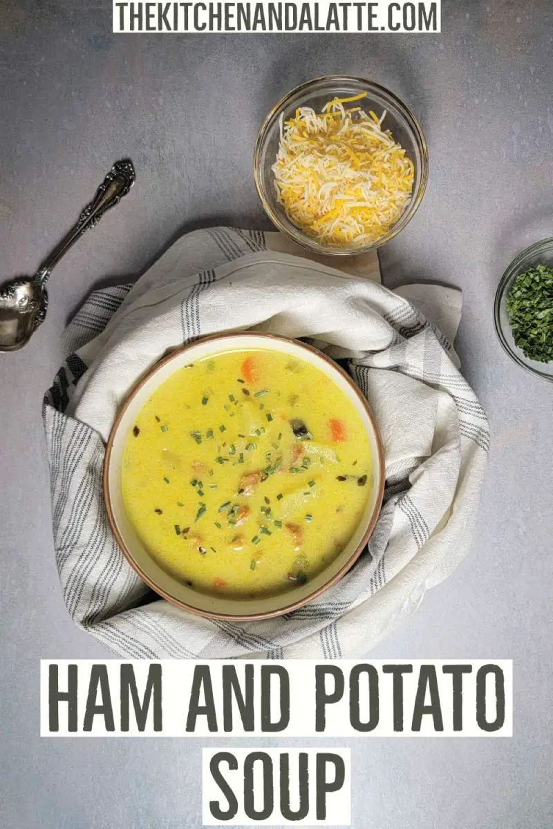 Ham and potato soup Pinterest graphic. Soup in a small serving bowl with shredded cheese and chives in small prep bowls as an optional topping.