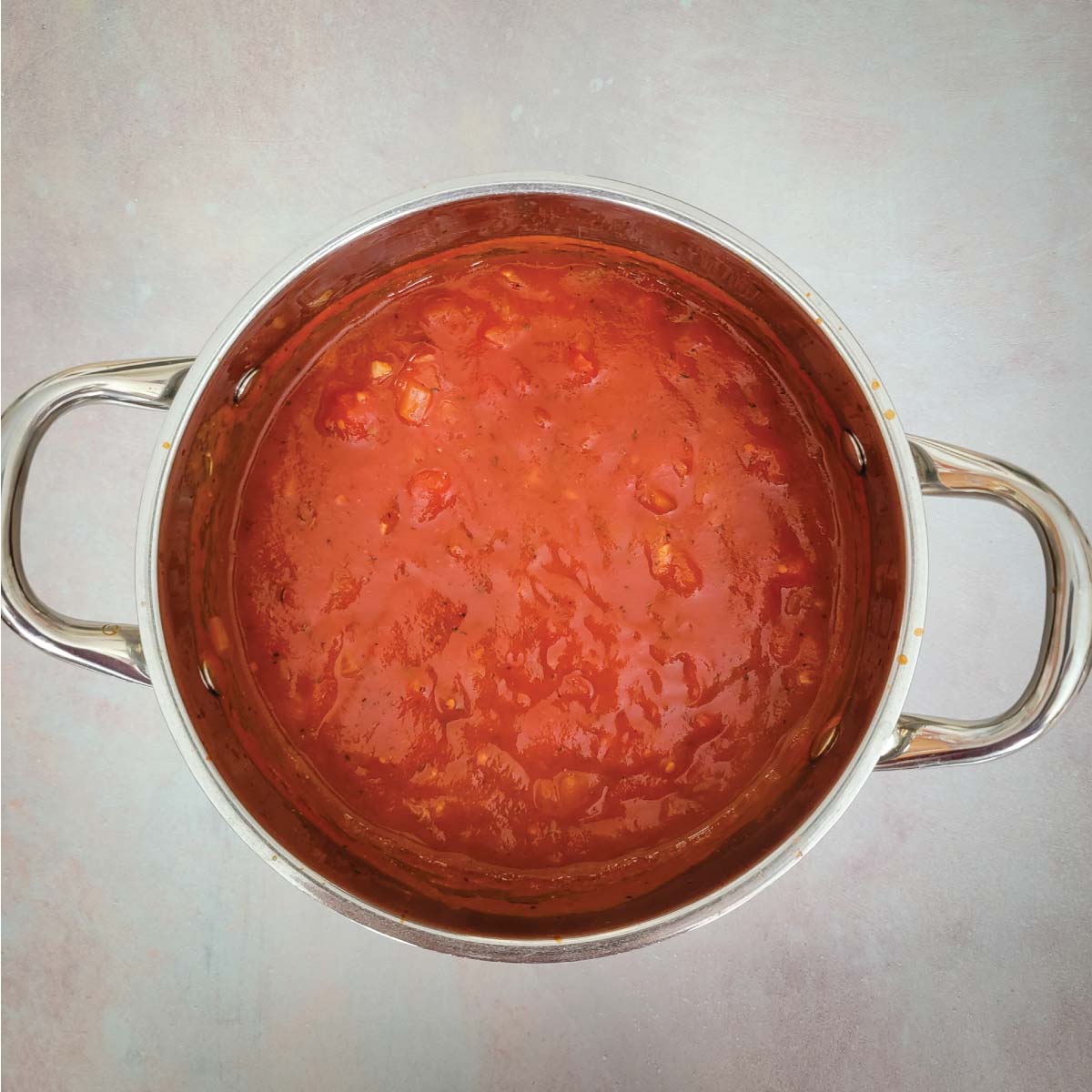 Lasagna sauce in a sauce pot after cooking ready to use.