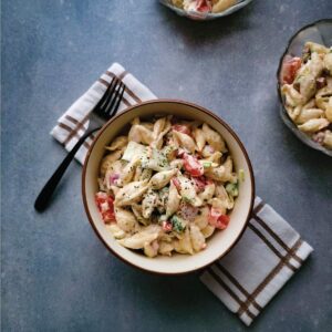 Ranch pasta salad in serving bowls ready to eat topped with parsley as a garnish.