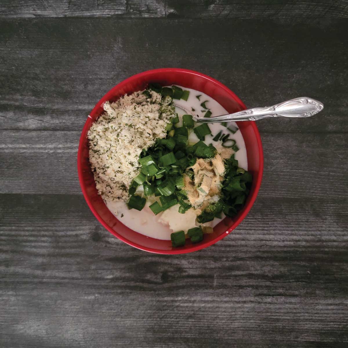 Mayonnaise, milk, chopped scallions, garlic powder, salt and ranch seasoning in a bowl to make the dressing.