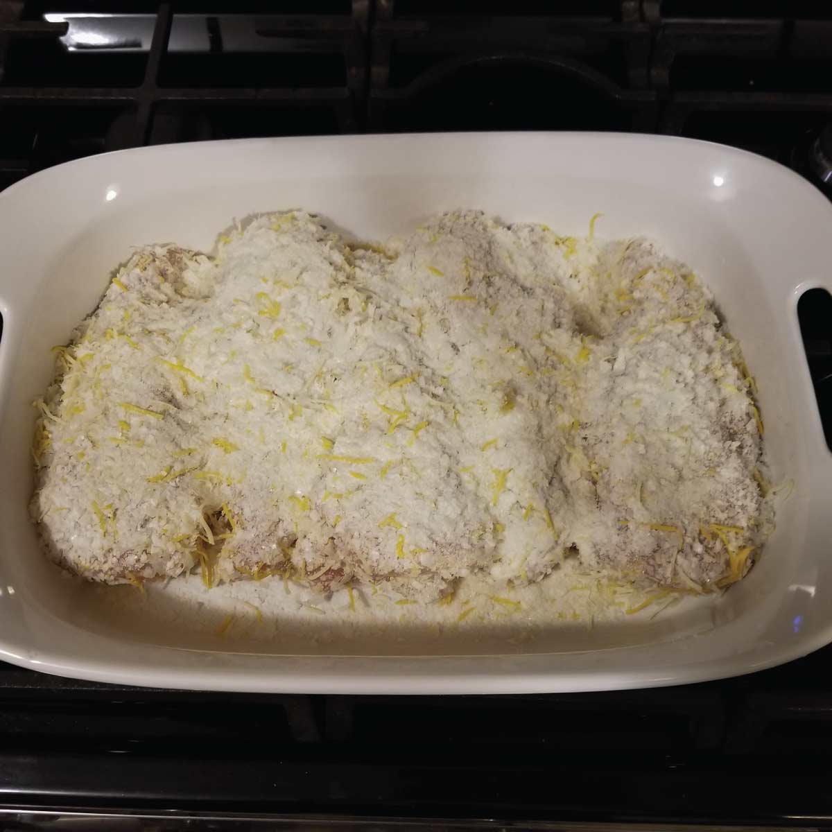 Chicken in a baking dish prepped and ready to bake.