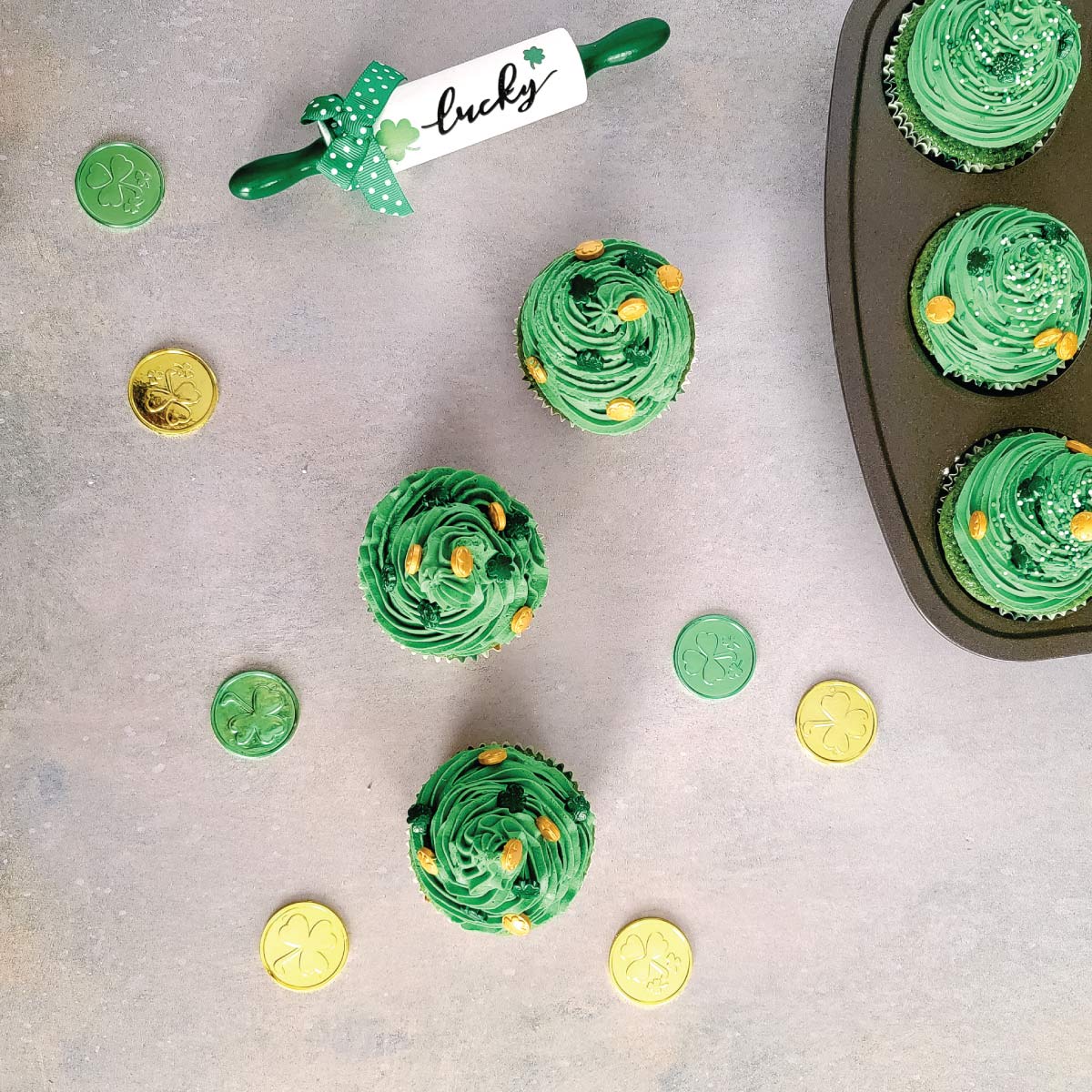Green cupcakes with green icing decorated for St. Patrick's Day.