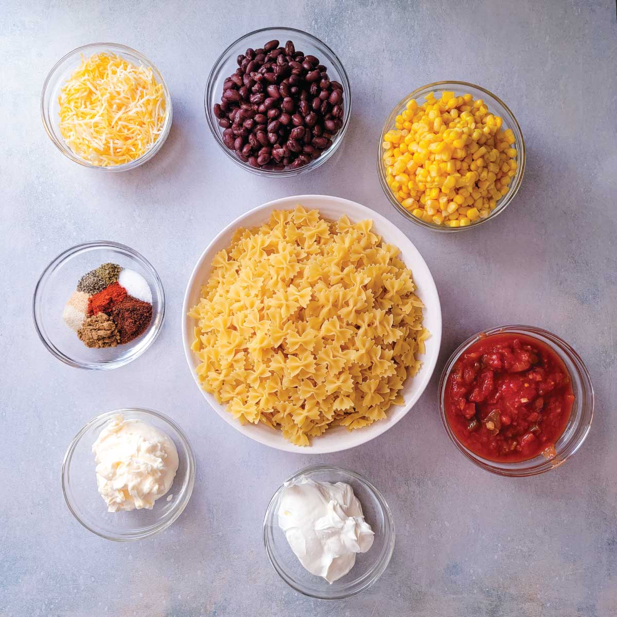 Ingredients for the pasta salad prepped in bowls ready to use.