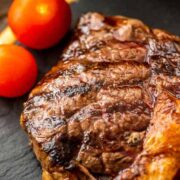 Steak resting on a plate after cooking.