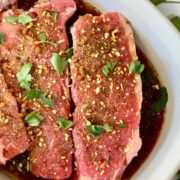 Steaks in a marinade ready to cook.