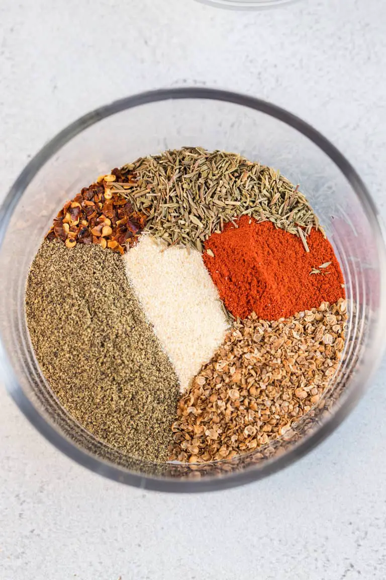 Spices added to a prep bowl for the steak seasoning.