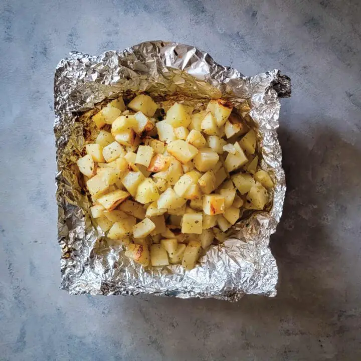 Cooked ranch potatoes in an open foil pack ready to serve.