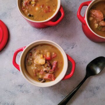 Ham and bean soup in small serving size soup dishes ready to eat.