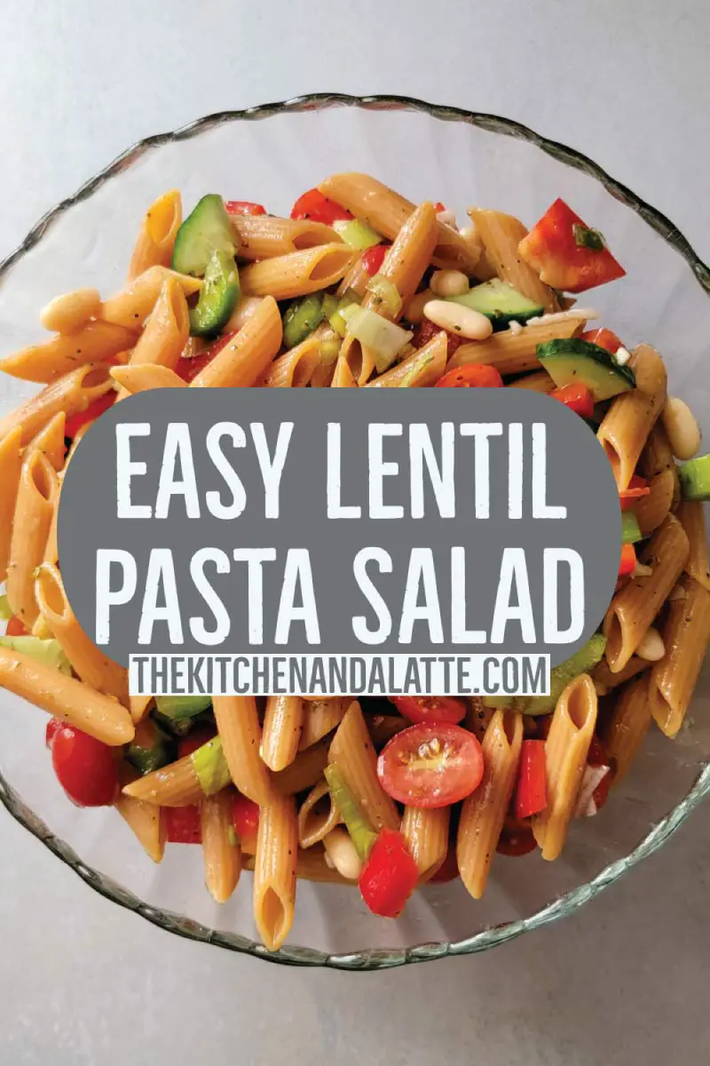 Red lentil pasta salad Pinterest graphic. Salad prepared in a serving bowl ready to serve.
