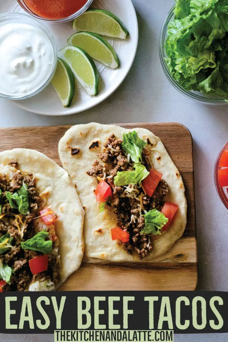 Easy beef tacos Pinterest graphic - soft tacos made on homemade tortillas with taco toppings in prep bowls around them.