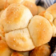 pull apart rolls topped with coarse salt in a basket ready to serve.