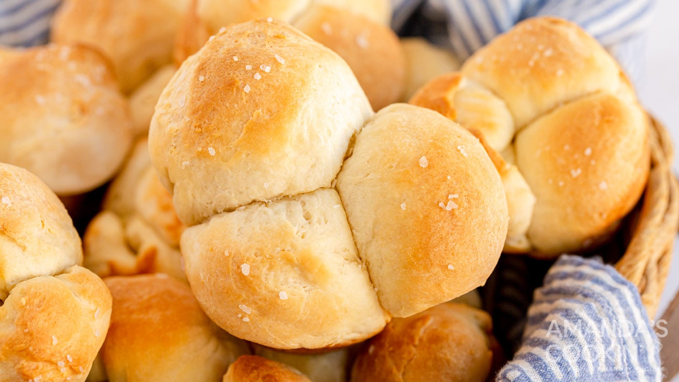 pull apart rolls topped with coarse salt in a basket ready to serve.