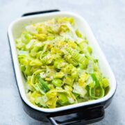 Creamed leeks in a baking dish after cooking ready to serve.