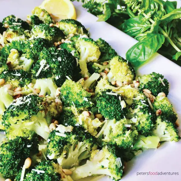 garlic parmesan broccoli topped with fresh parmesan in a serving dish ready to serve.