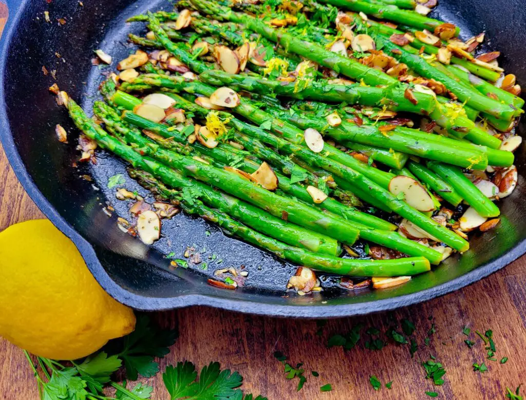 Asparagus amandine in a cast iron skillet ready to serve.