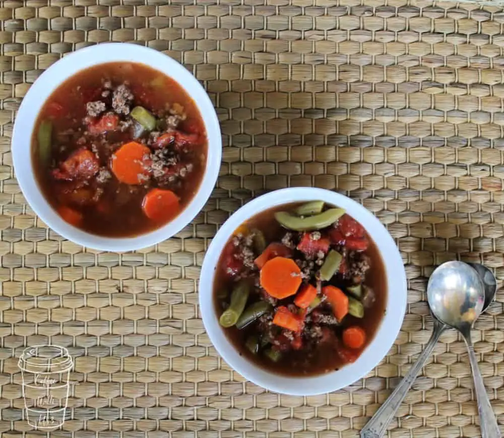 hamburger vegetable soup in bowls ready to eat.