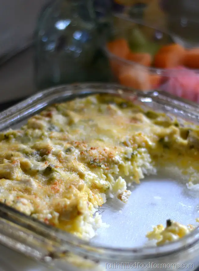 cheesy chicken and broccoli rice casserole in a dish being served.