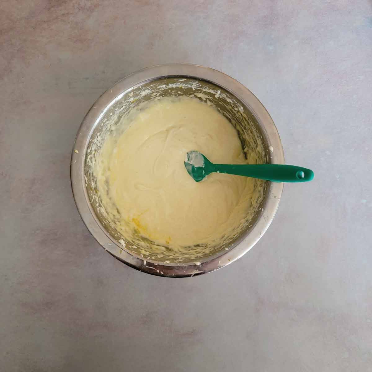 Cheesecake batter after using the mixer with just a little bit of egg needing to be stirred with a spatula so not to over beat it.