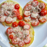 3 squash mini pizzas with melted cheese on top on a serving plate ready to serve.