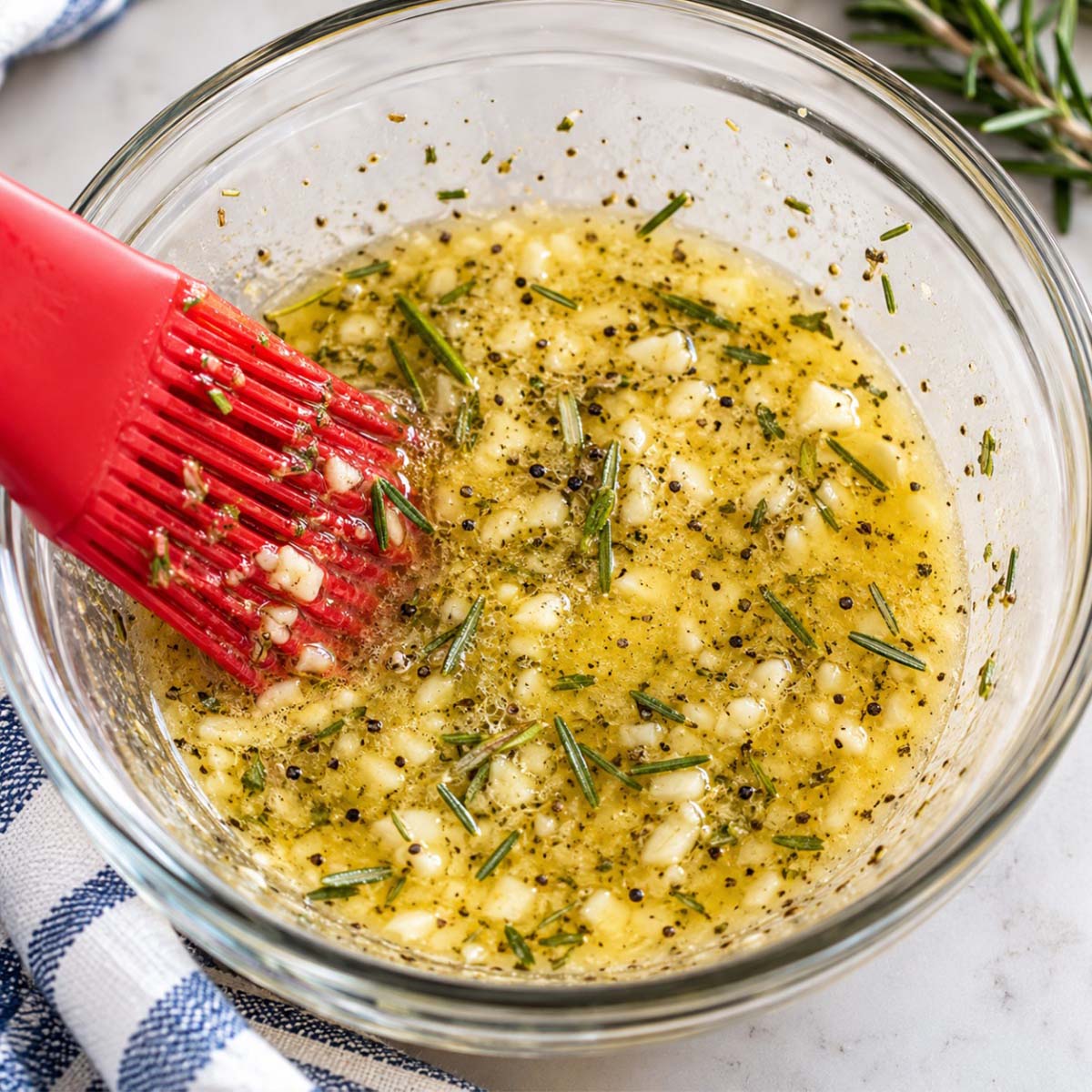 rosemary garlic butter prepped in a small glas prep bowl.